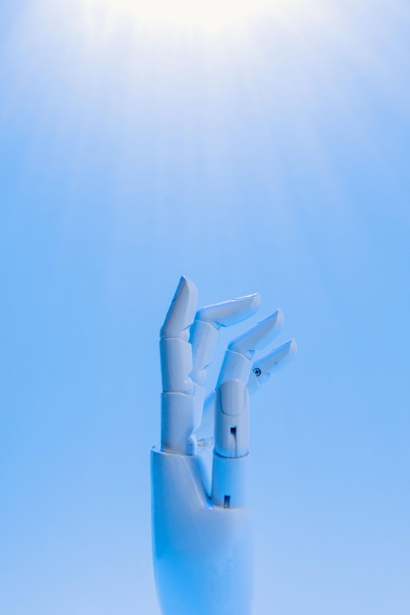 Robotic hand reaching into light — the future of digital surgery